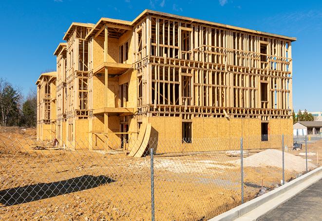 a close-up of temporary chain link fences enclosing a construction site, signaling progress in the project's development in Spring Valley Lake CA